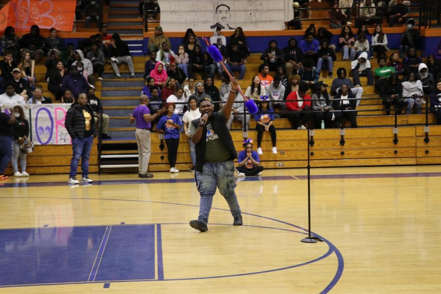 Junior Jeyvon Chatman holds the spirit stick in the air for the crowd to see. The juniors won the spirit stick as a prize for the most school spirit during the pep rally. 