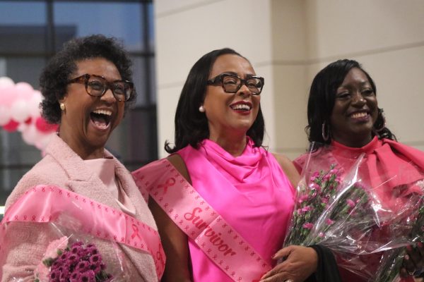 Three breast cancer survivors including Superintendent Kim Moore (center) are honored at the end of the fashion show on Oct. 21. The event raised $350 for a charity yet to be determined.