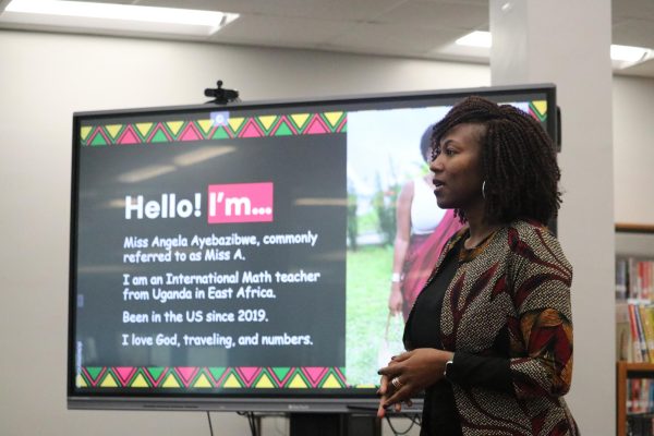 Angel Ayebazibwe introduces herself to a crowd of students. In the library, the first speaker of many, shared her Black History month presentation.