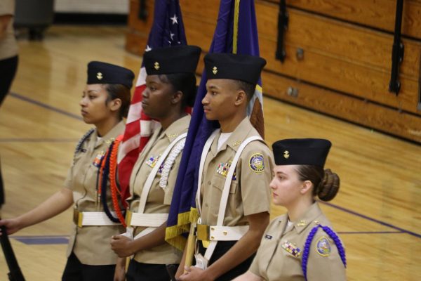 JROTC Color Guard members Astoria Trick, Mayakai Robinson, William Beasley, and Hailey Perez stand at attention. Color Guard performs at most school events.