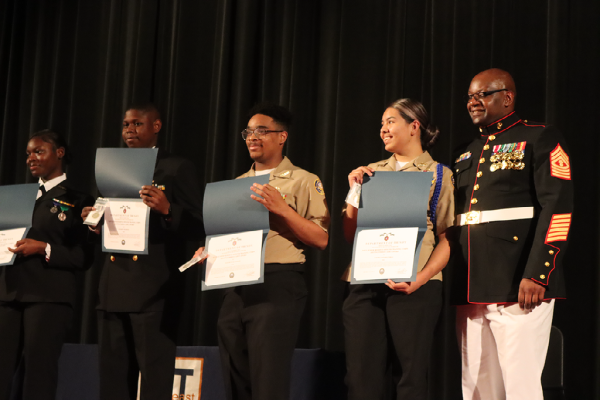 Master Guns awards the Distinguished Cadet Award to Jordin Hallman, Jamarion Thompson, Damarcus Henderson, and Zahury Tobias Castanon. These cadets exemplified the core values of the Navy and Marine Corps. 