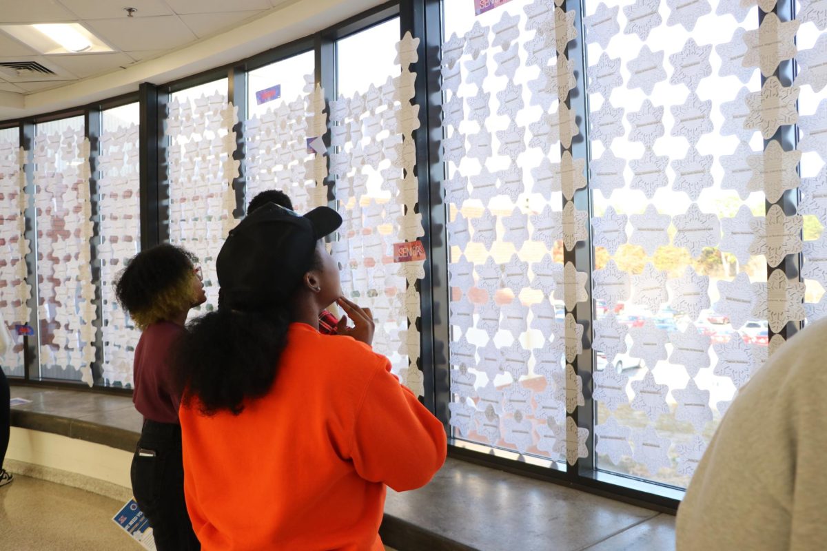 Students glimpse at paper snowflakes that commemorate the Winter Wonderland. Sophomore House scheduled the Winter Wonderland dance.