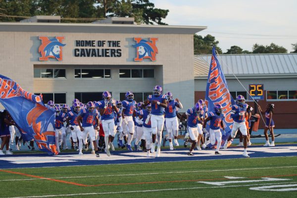 The football team running through their banner before the Spring Valley game. 