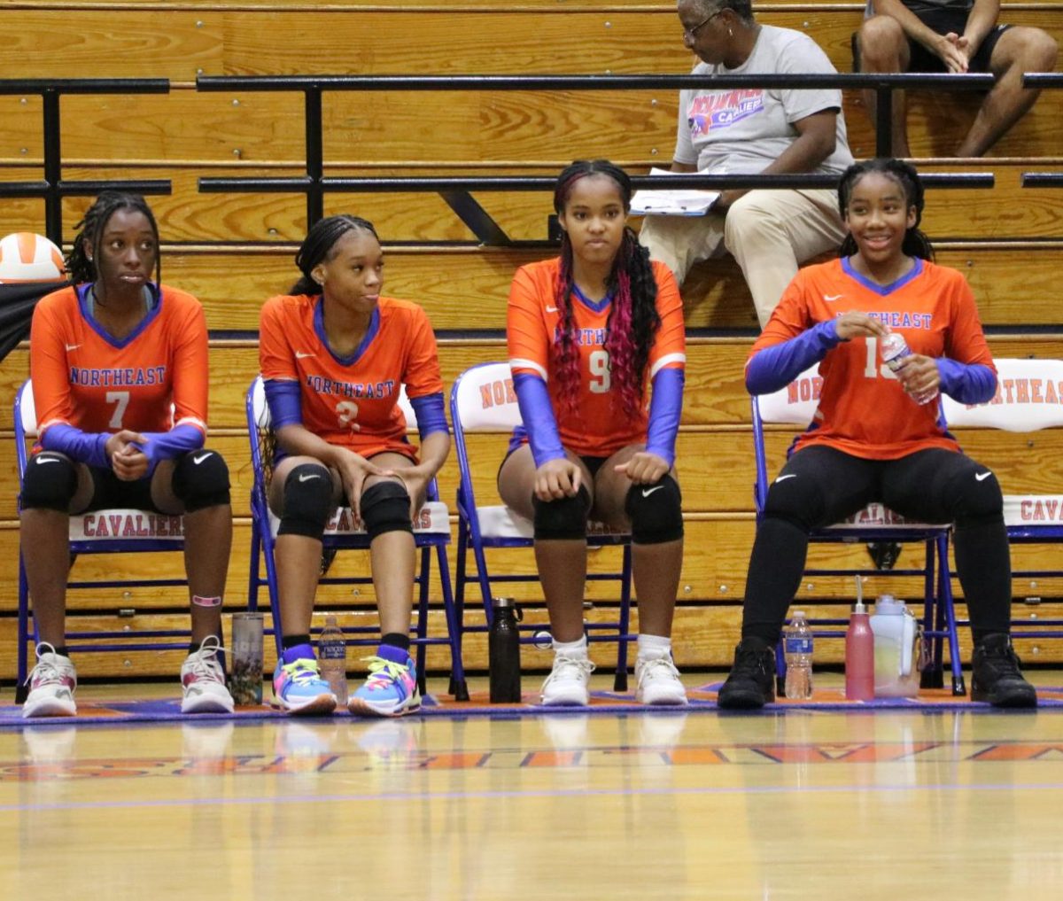 The bench players focus on the game.