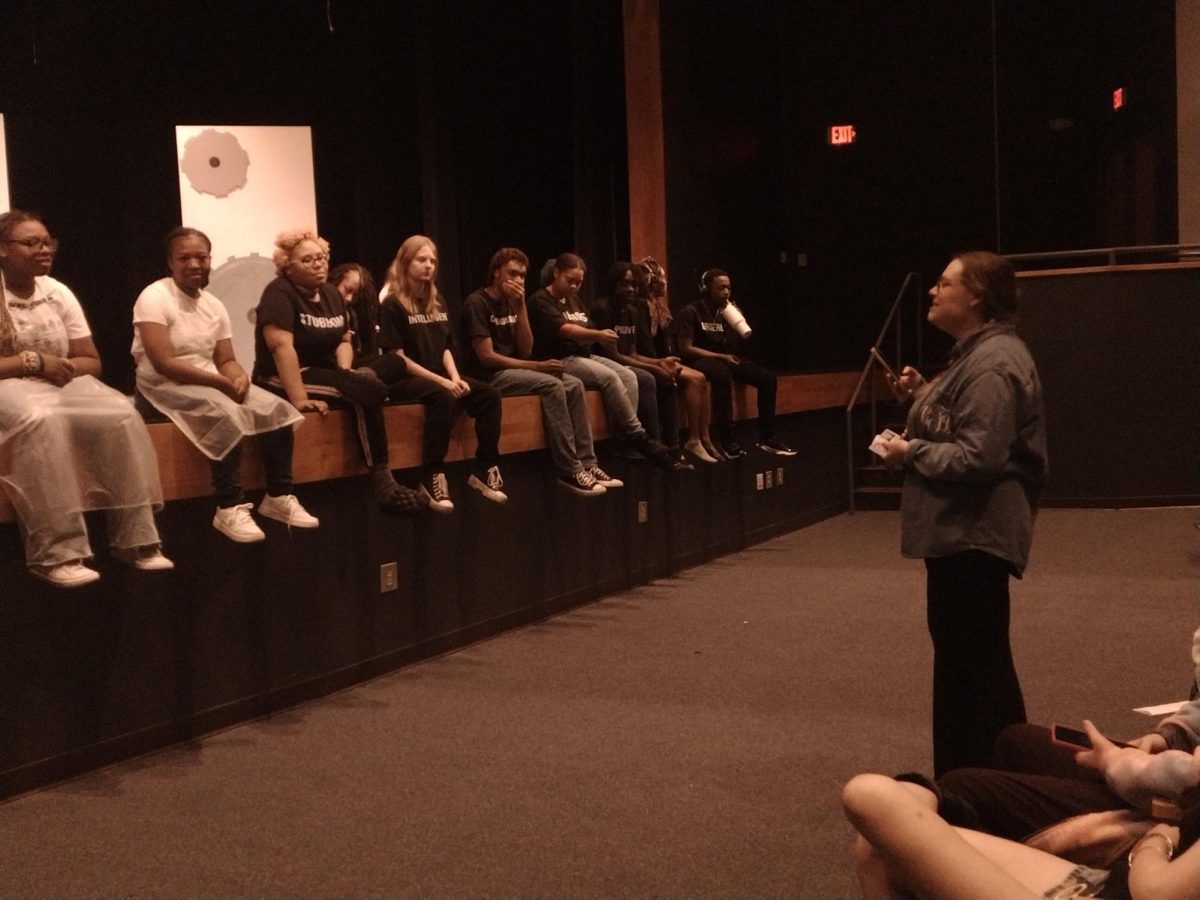 Charlotte Fletcher speaks to theater participants.