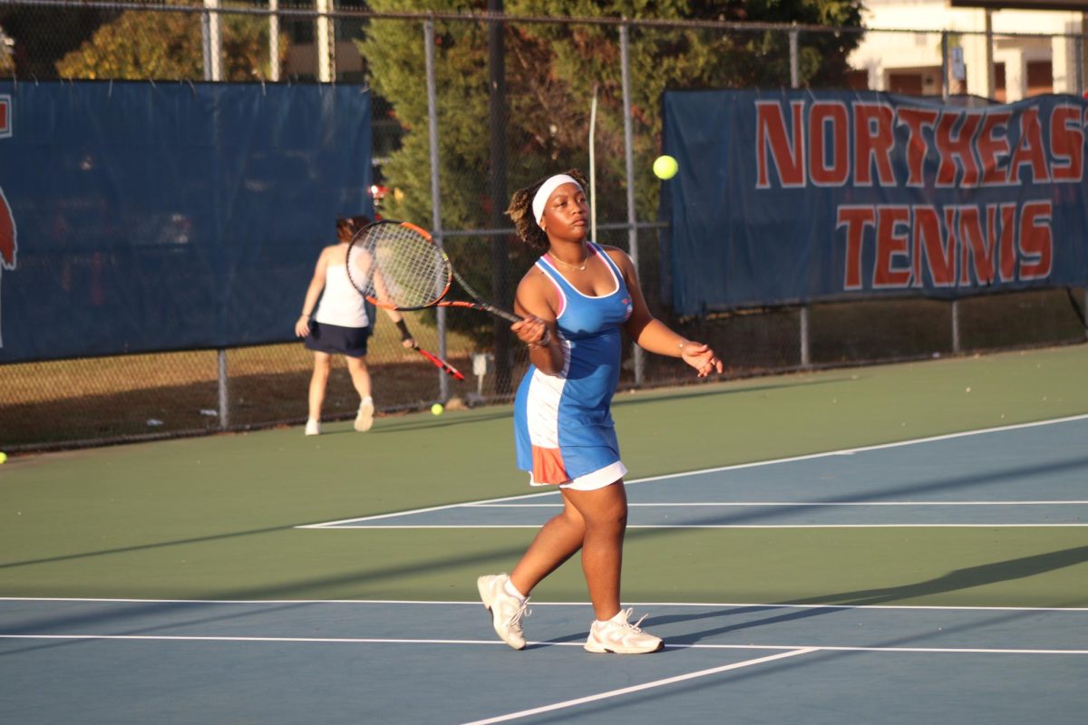 Junior Journey Schofield returns the ball during her match.