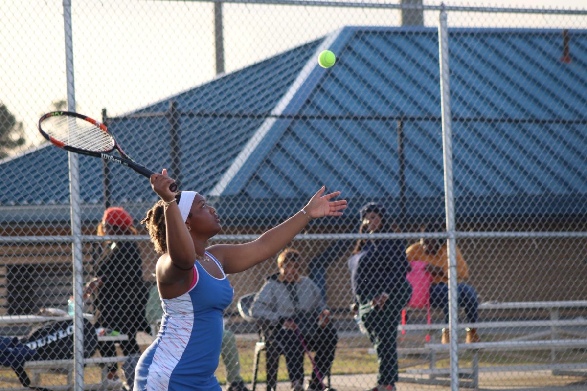 Journey Schofield serves the ball during a game.