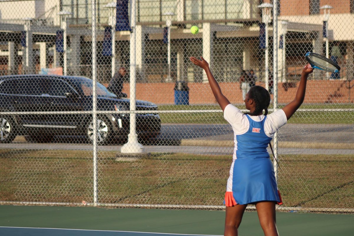Allison King-Turner serves the ball during a game.