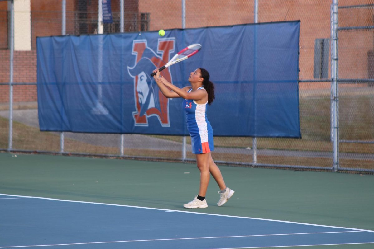 Dulce Calix-Echeverria serves the ball during a game.