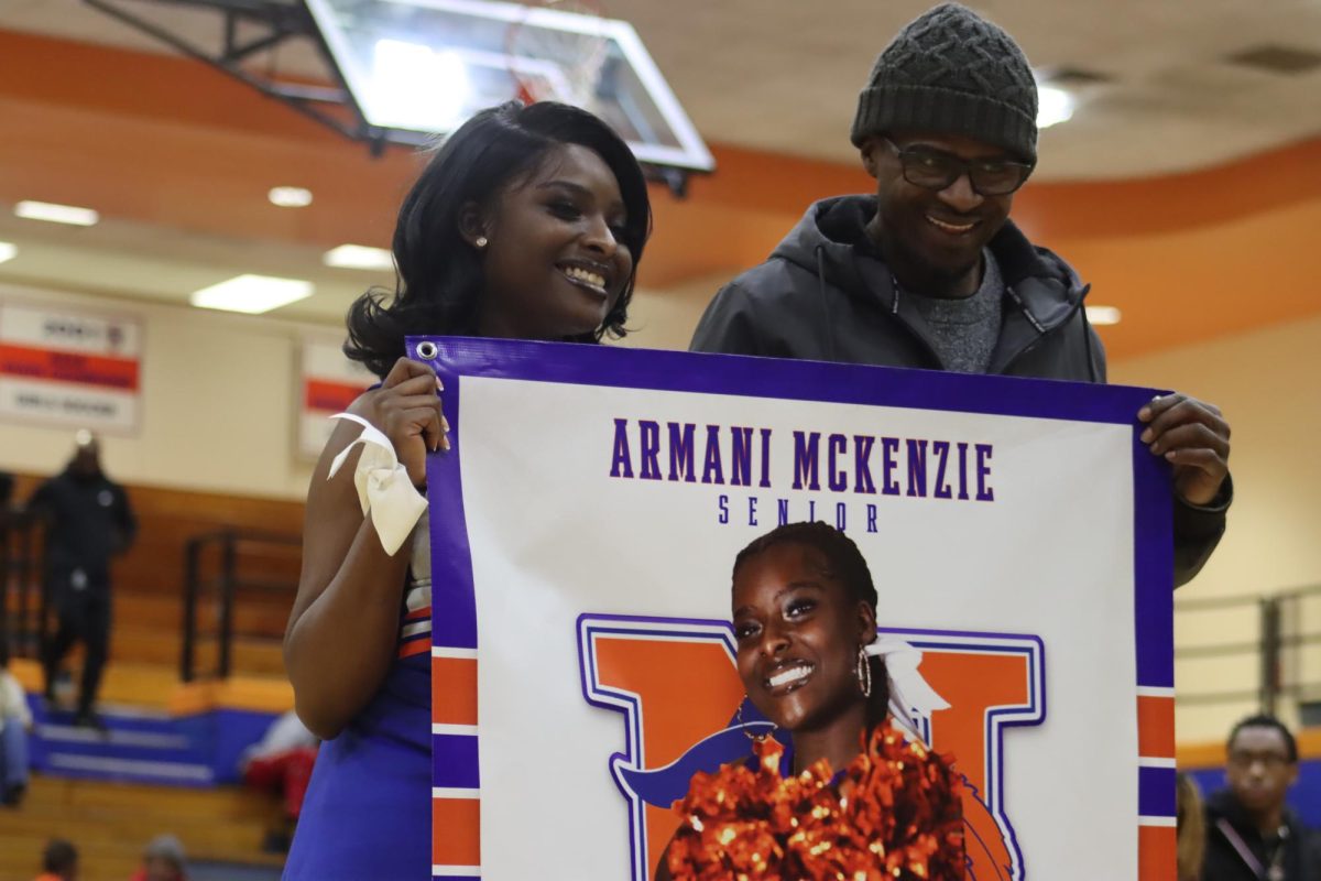 Senior Armani Mckenzie poses with family.