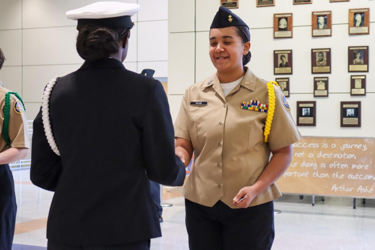 Petty Officer Samara Rouse gives pins to other cadets.