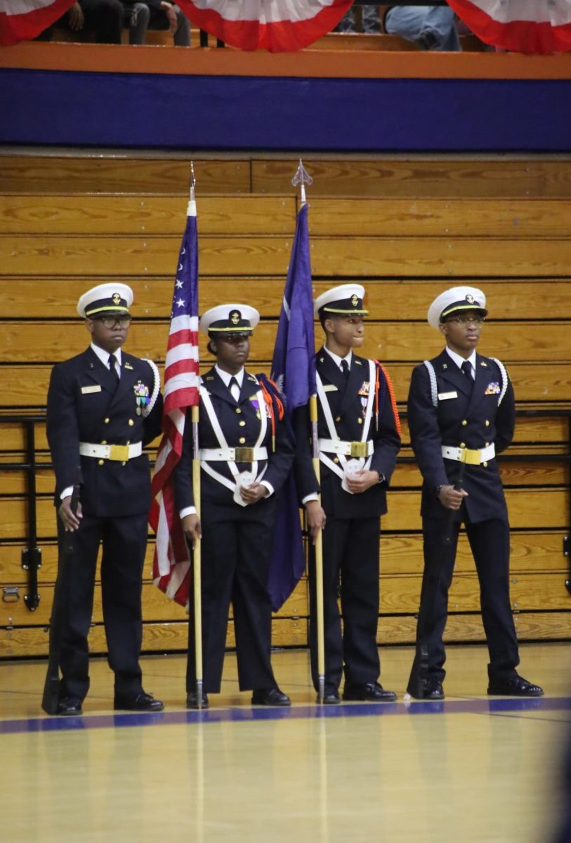 Color Guard members stand at ease.