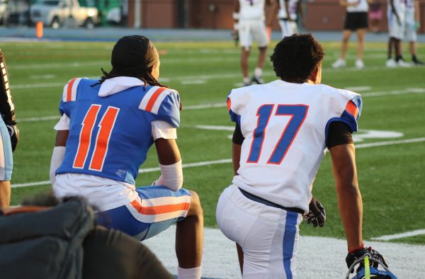 Freshman Jimmele Smith and sophomore Isaiah Smalls on sidelines.