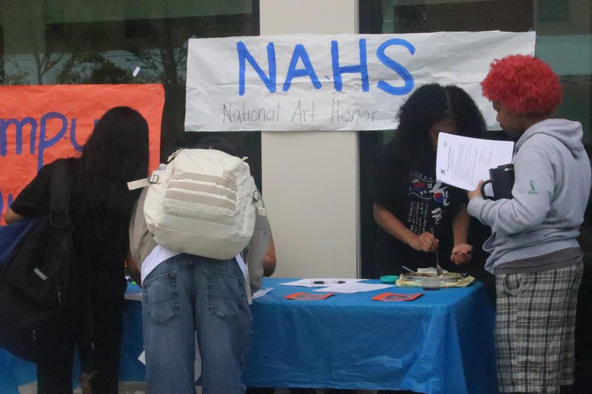 Interested students sign up for the National Art Honor Society.