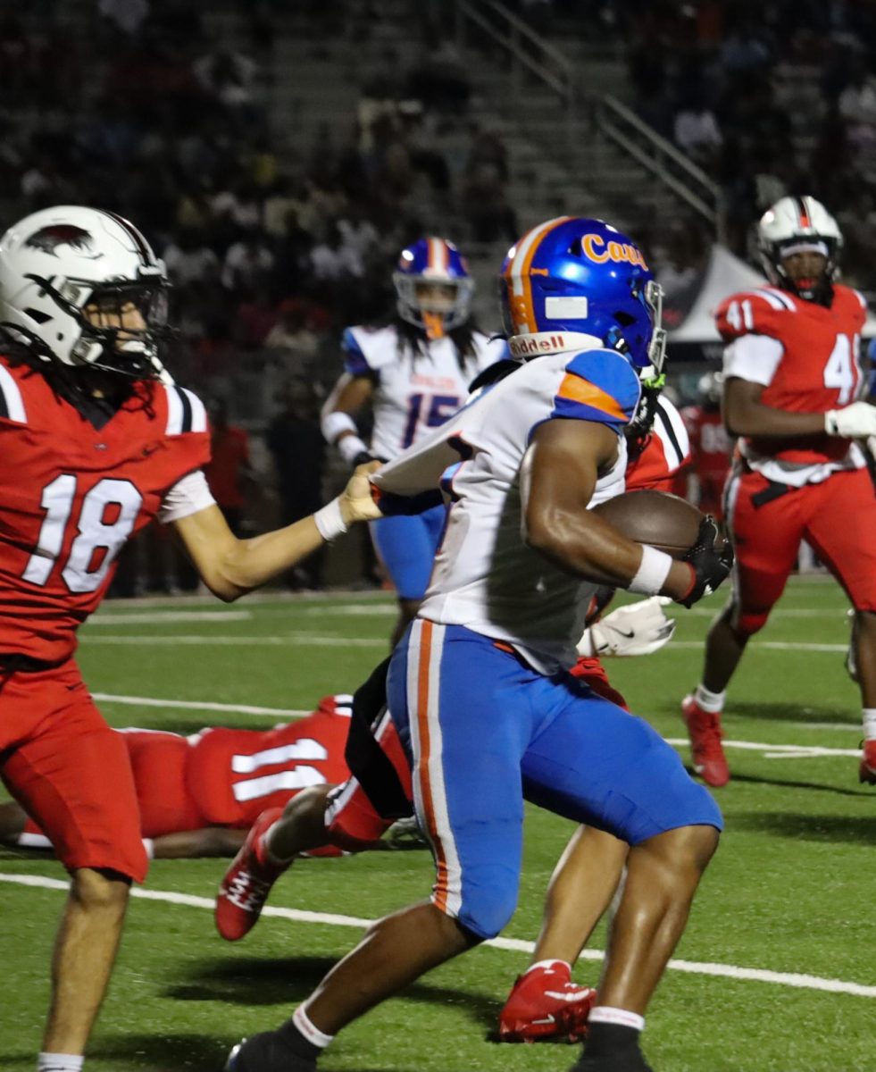 Opponents shove junior Isaiah Smalls.