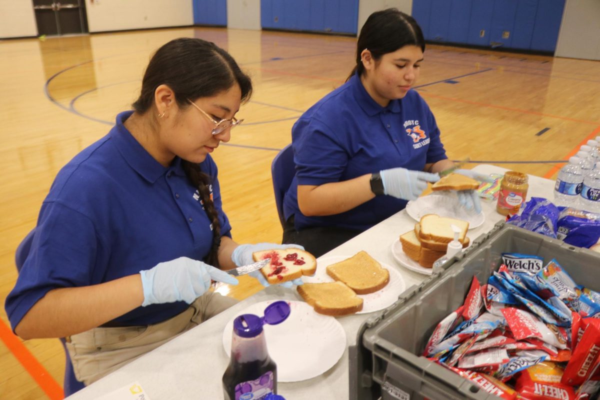 NJROTC members prepare peanut butter and jelly sandwiches for donors. To prevent fainting, donors must keep up their blood sugar.