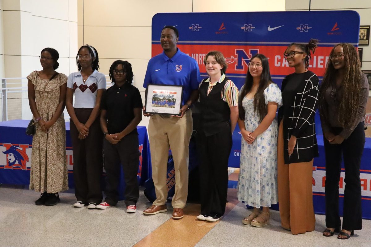 The girls golf team and Coach pose for a photo. In order, from left to right; Jamaya Wilson (sophomore), Lani Paul (senior), Jade Milton (junior), Bailey Jones (junior), Ruth Martinez (junior), Nylah Curney (junior), and Rihanna Williams (senior).