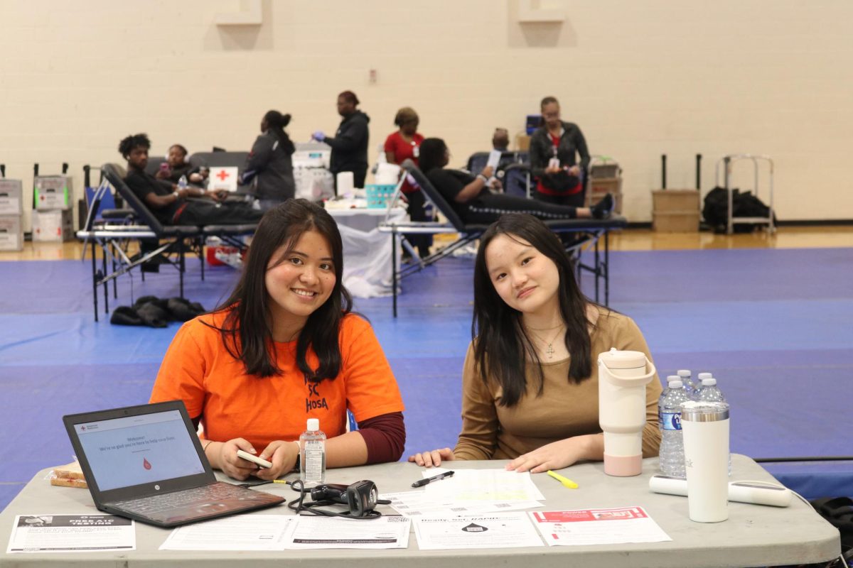 Marcelina Imbo and Jyra Duligas at the entrance table.