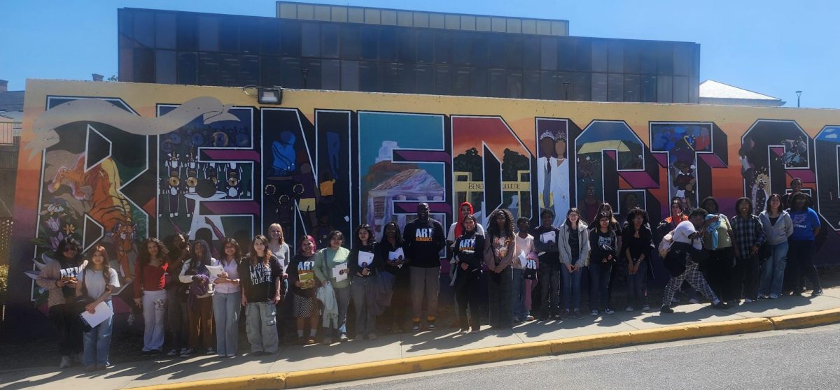 A group photo of all the NAHS and PCA art students in front of the Benedict college Mural. 