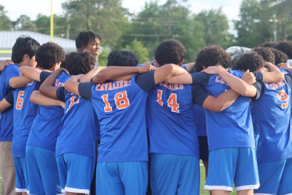 Boys varsity soccer team huddles before the game.